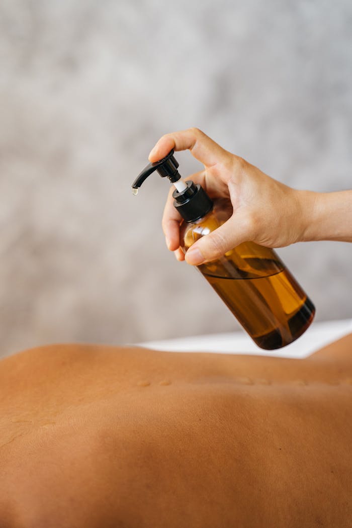 A relaxing massage with oil, showcasing a therapist's hand in a soothing spa setting.